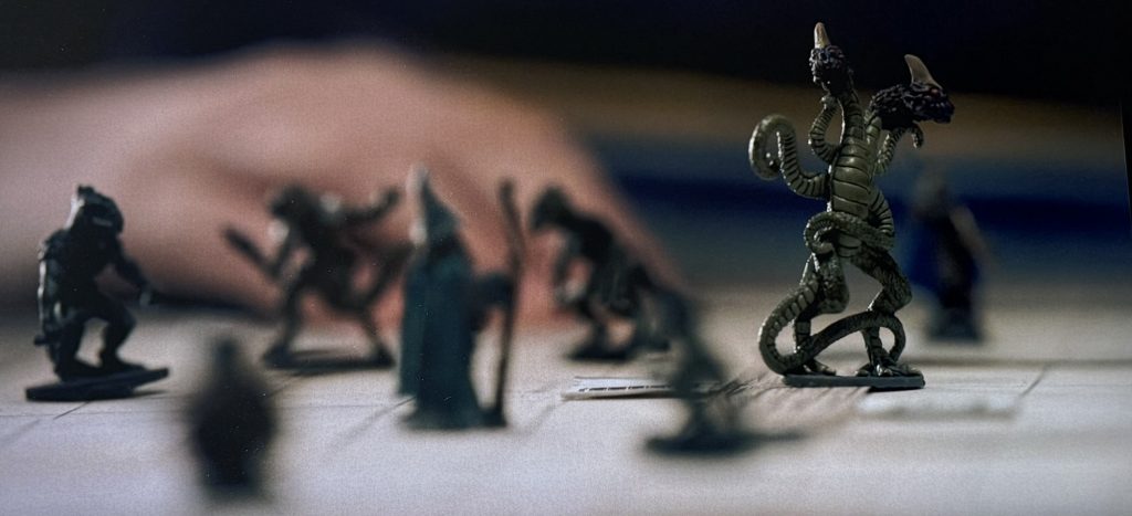 Stranger Things screenshot. DnD gameboard with several figures, including the Demogorgon. 